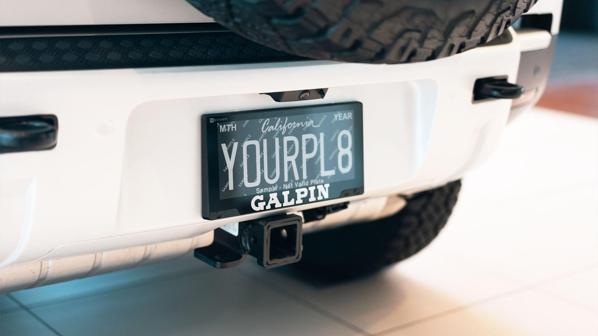 White Jeep with a Reviver RPlate on the rear